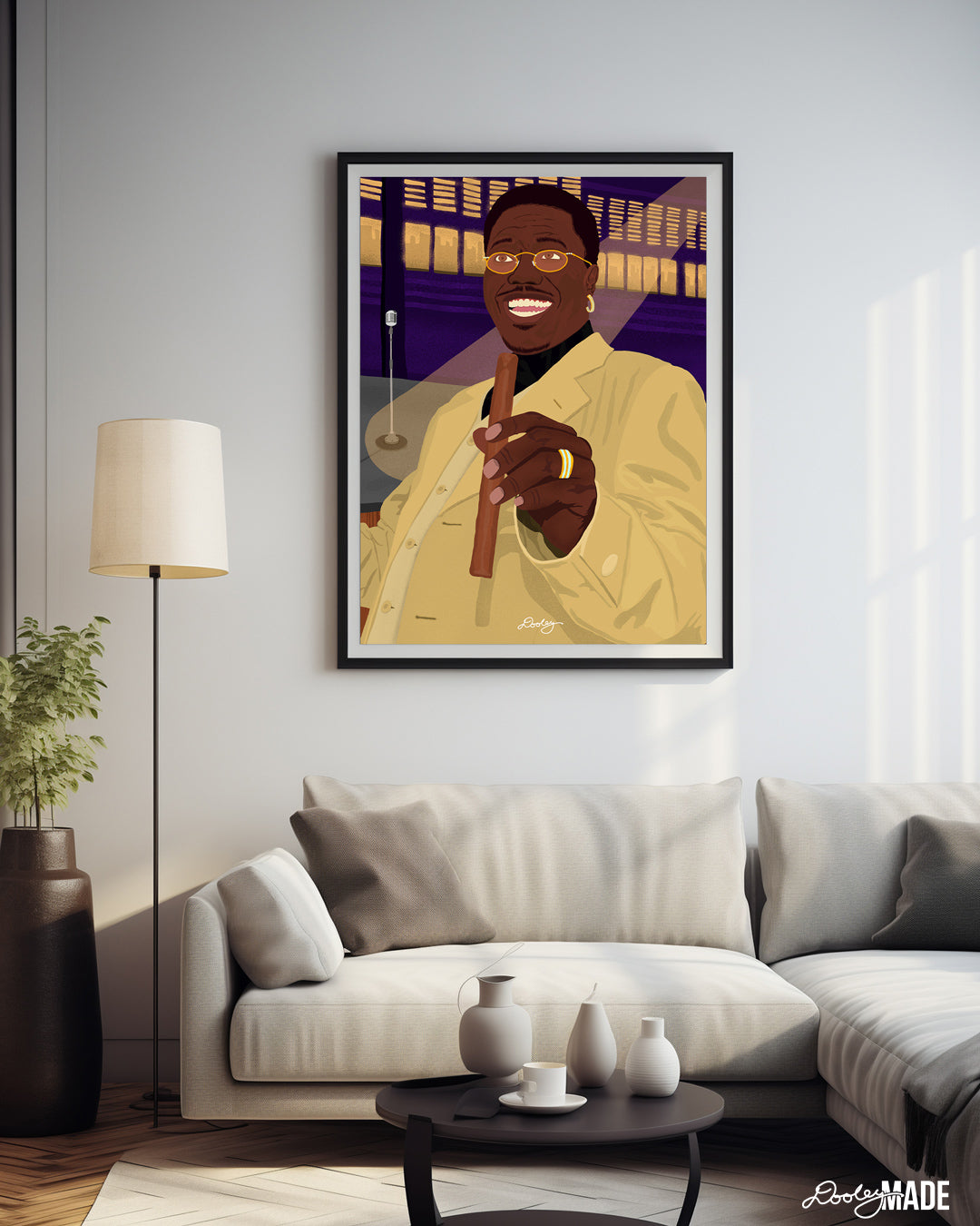 A beautiful illustration of Bernie Mac holding a cigar hanging on the wall above a couch in a modern living room.