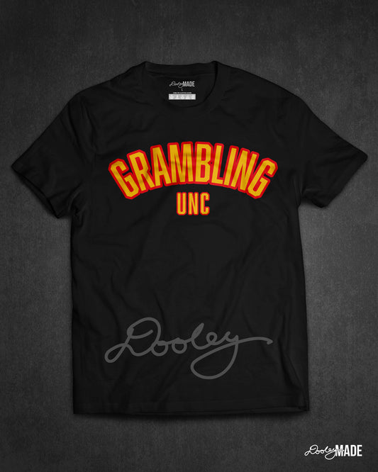 A black "Grambling Unc" shirt with arched wording in gold and black.