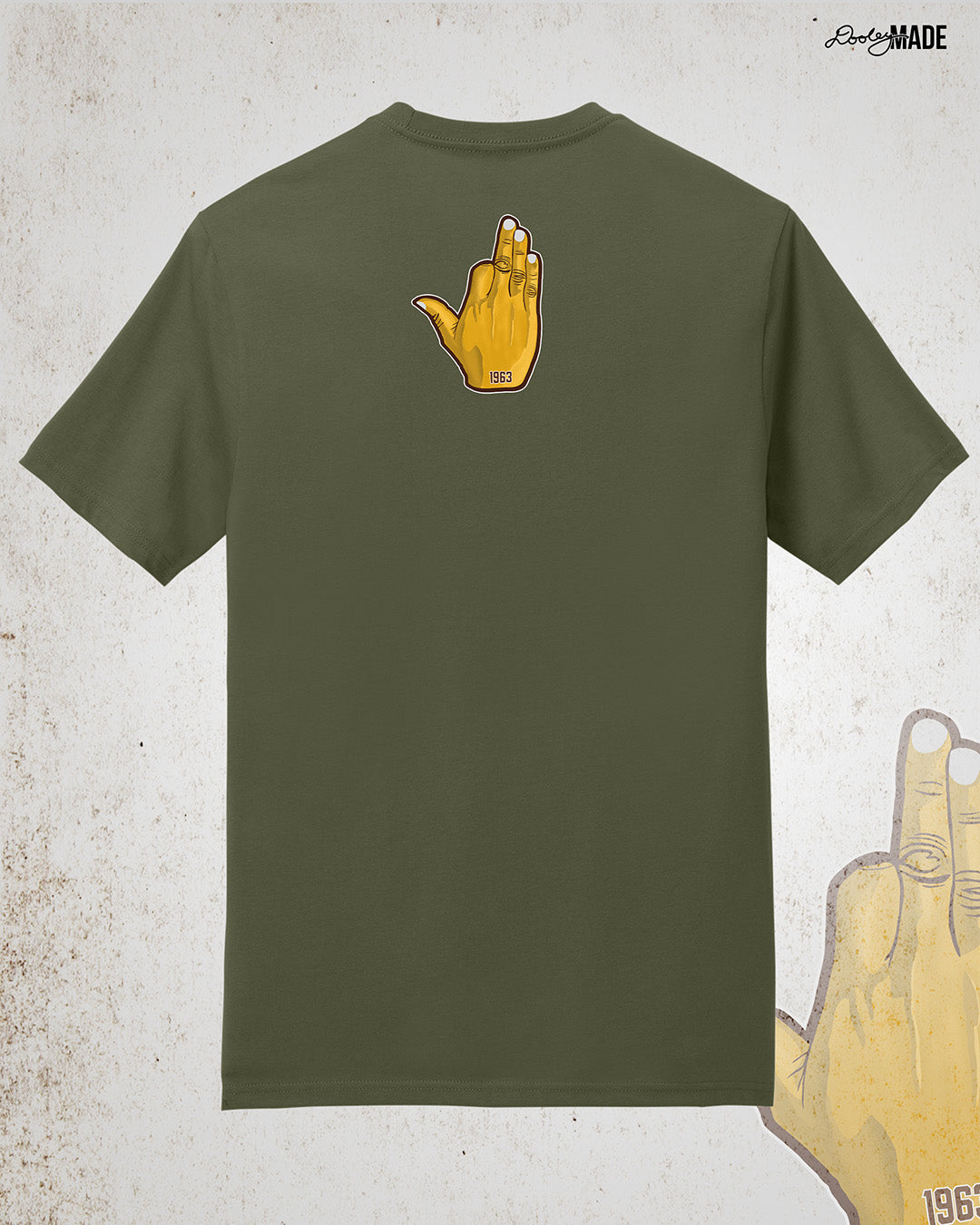 Image showing the back of a customizable Iota Phi Theta shirt with an upper-back print of a gold, brown, and white "Ow-Ow" hand sign with "1963." Shirt is on a textured white background.