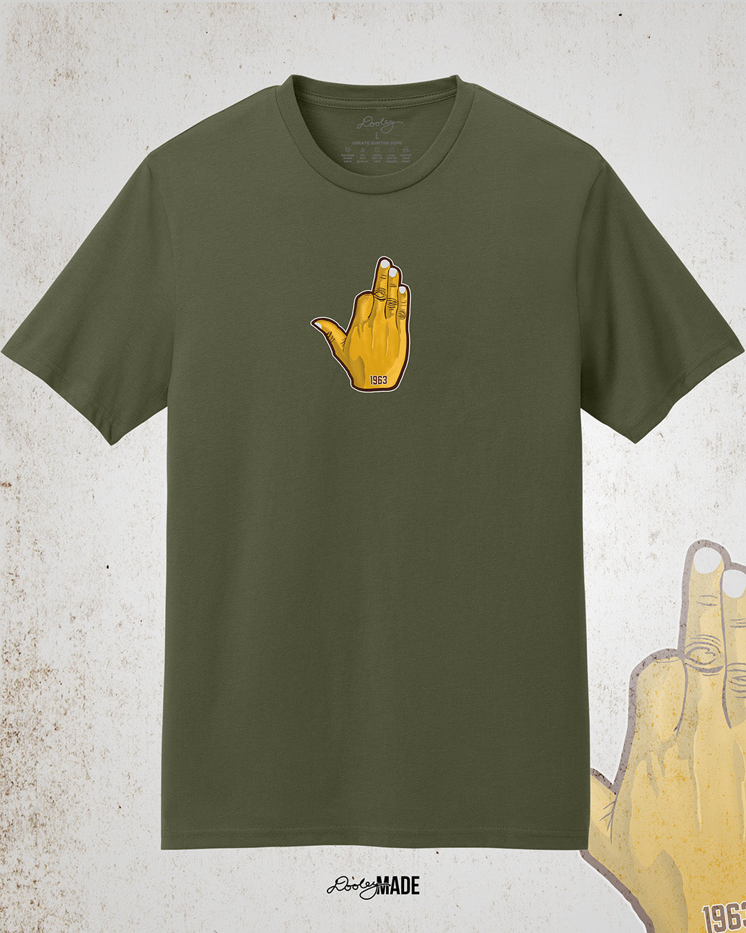 Image showing the front of a customizable Iota Phi Theta shirt with middle chest print of a gold, brown, and white "Ow-Ow" hand sign with "1963." Shirt is on a textured white background.