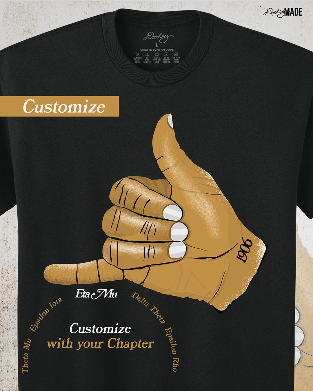 A customizable Black t-shirt with an old gold Alpha Phi Alpha Fraternity, Inc. "ICE" hand sign with "1906" text on the wrist. Image on grunge textured white background. The words "customize with your chapter" are below graphic with a text selection when showing customization options.