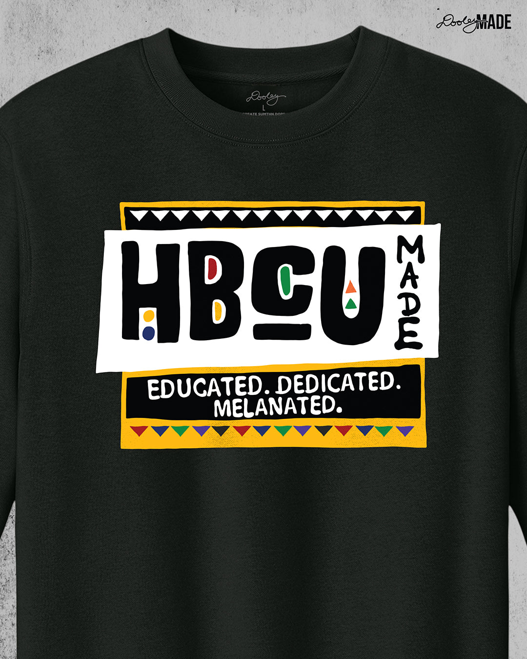 A premium black crewneck sweater featuring a bold HBCU Made 90s Martin Show themed design featuring the text "Educated, Dedicated, Melanated. The design is white, black, yellow, and various other vibrant colors.