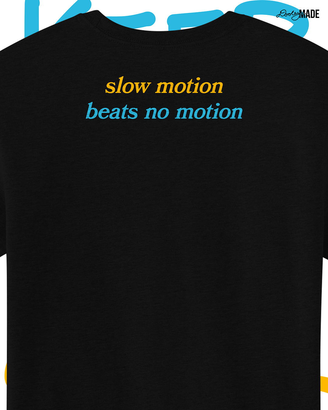 Heavyweight Black t-shirt with 'slow motion beats no motion' text on the back, on a white background, zoomed to show detail.