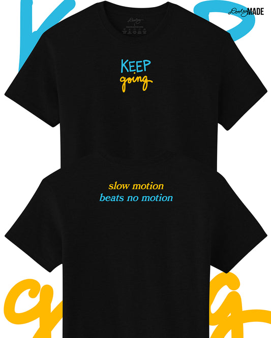 Heavyweight Black t-shirt with 'KEEP going' and 'slow motion beats no motion' text in blue and yellow on a white background. Shirts are stacked on each other vertically.