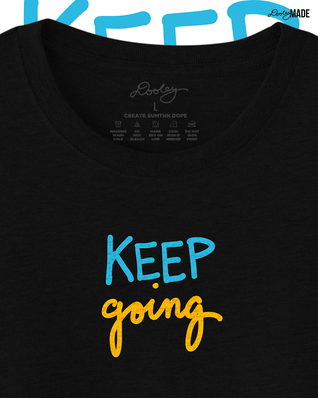 Heavyweight Black t-shirt with 'KEEP going' text in blue and yellow on a white background, zoomed to show detail.