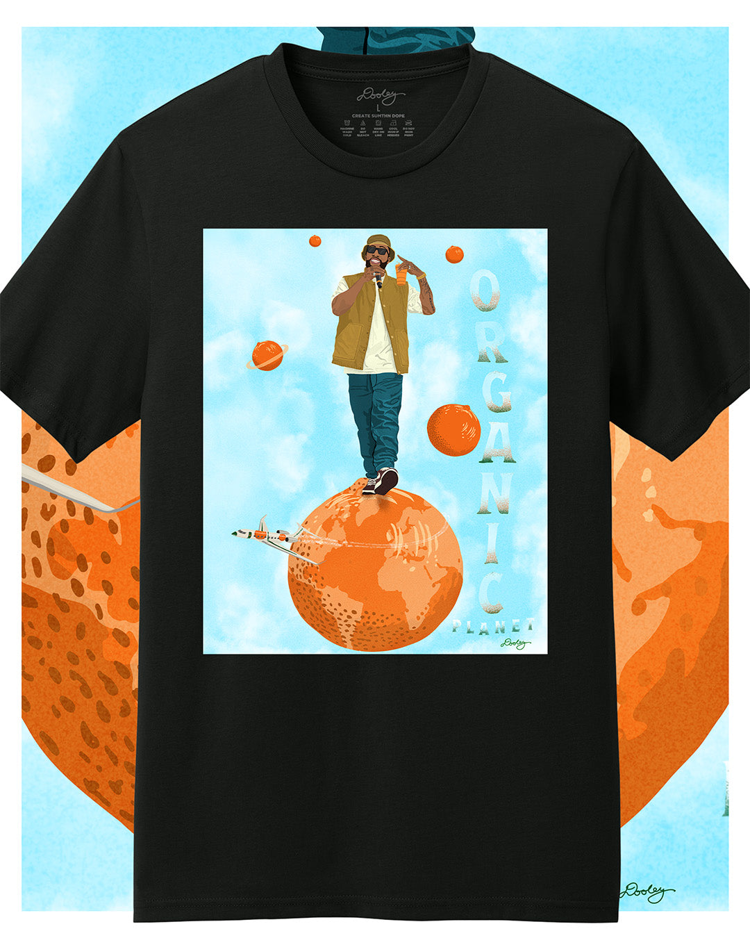 A black Larry June themed graphic t-shirt featuring a Larry June illustration of him standing on an orange planet with smaller floating orange planets, alongside the text "Organic Planet." Bold casual wear design blending creativity, luxury, and hip-hop culture.