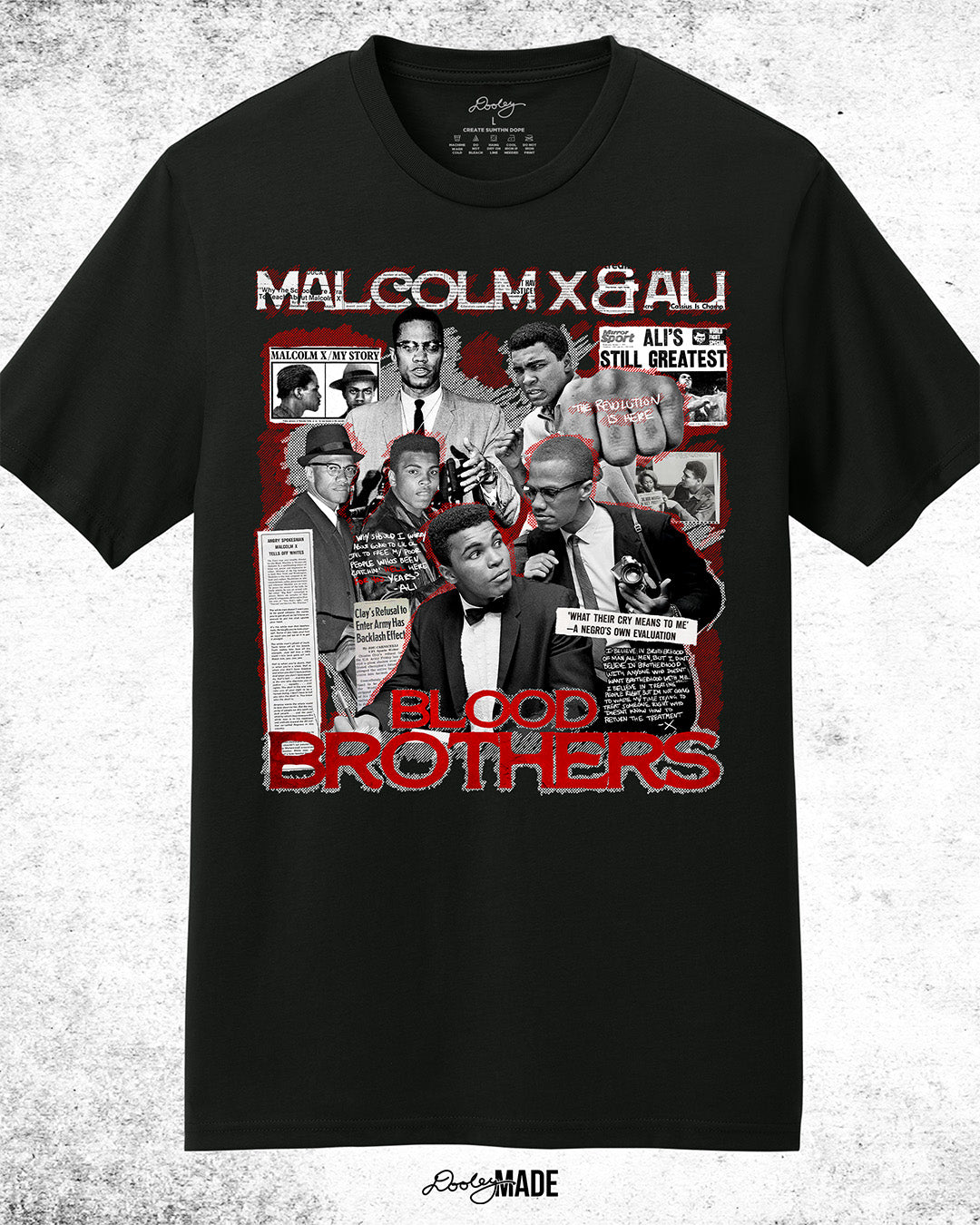 The front of a Black t-shirt featuring a collage of Malcolm X and Muhammad Ali with newspaper headlines and photos, titled 'Malcolm X & Ali: Blood Brothers' in bold red and white text.