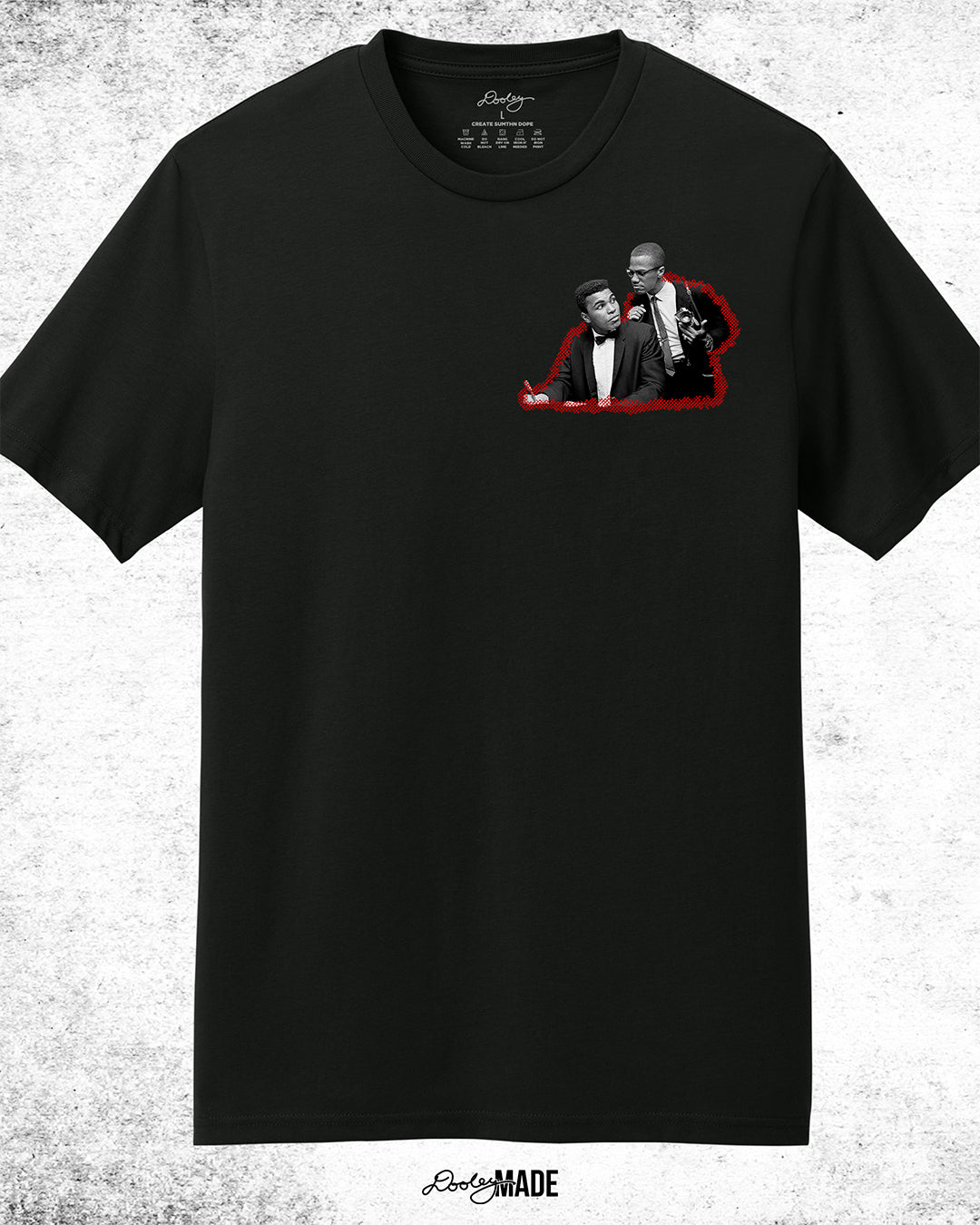 The front of Black t-shirt featuring a collage of Malcolm X and Muhammad Ali with newspaper headlines and photos, titled 'Malcolm X & Ali: Blood Brothers' in bold red and white text