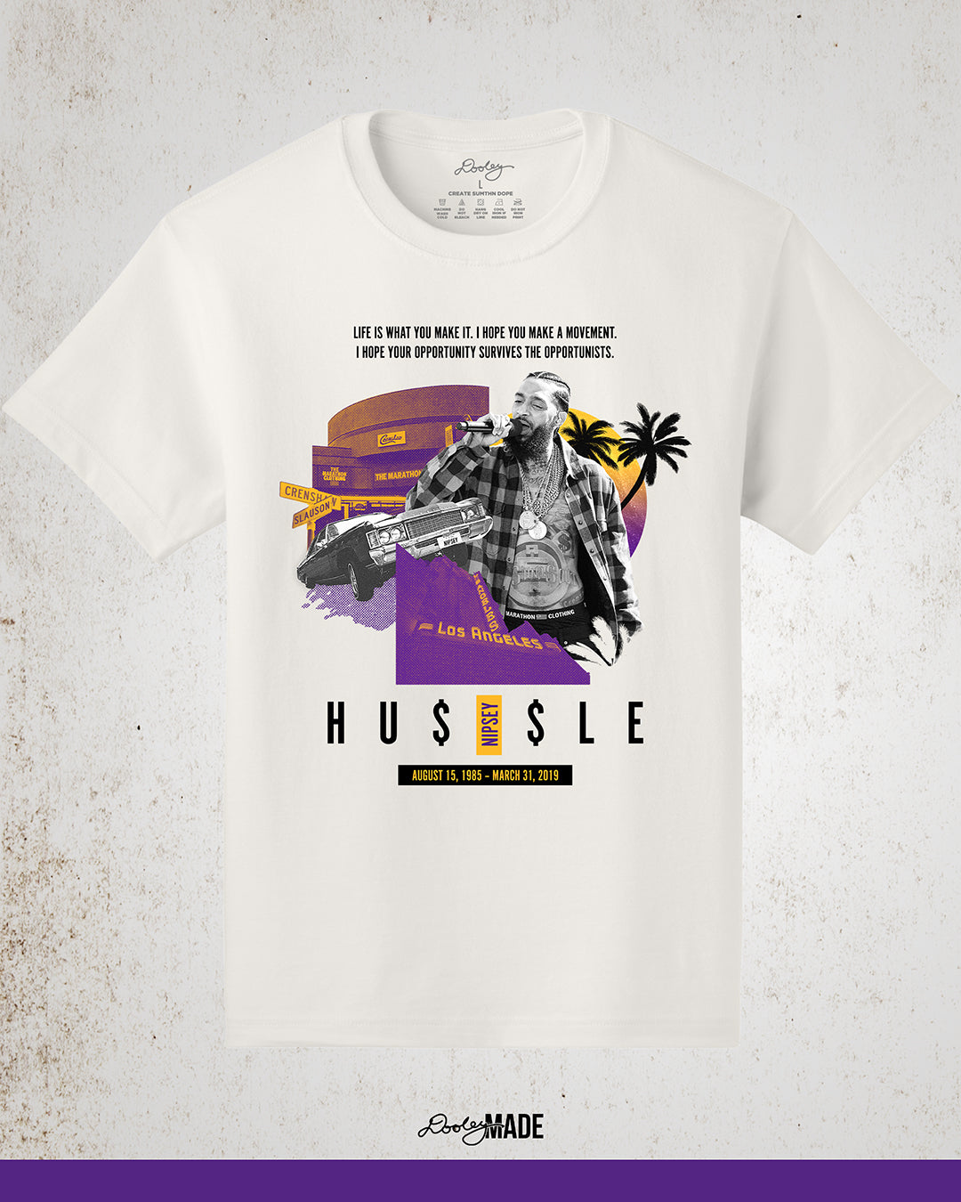 Vintage white Nipsey Hussle graphic t-shirt featuring “Sunsets on Slauson” artwork in LA purple and gold, depicting The Marathon Store on Slauson, a Chevy with NIPSEY plates, the Los Angeles Theatre marquee, a sunset, and palm trees—perfect hip-hop streetwear and Los Angeles apparel