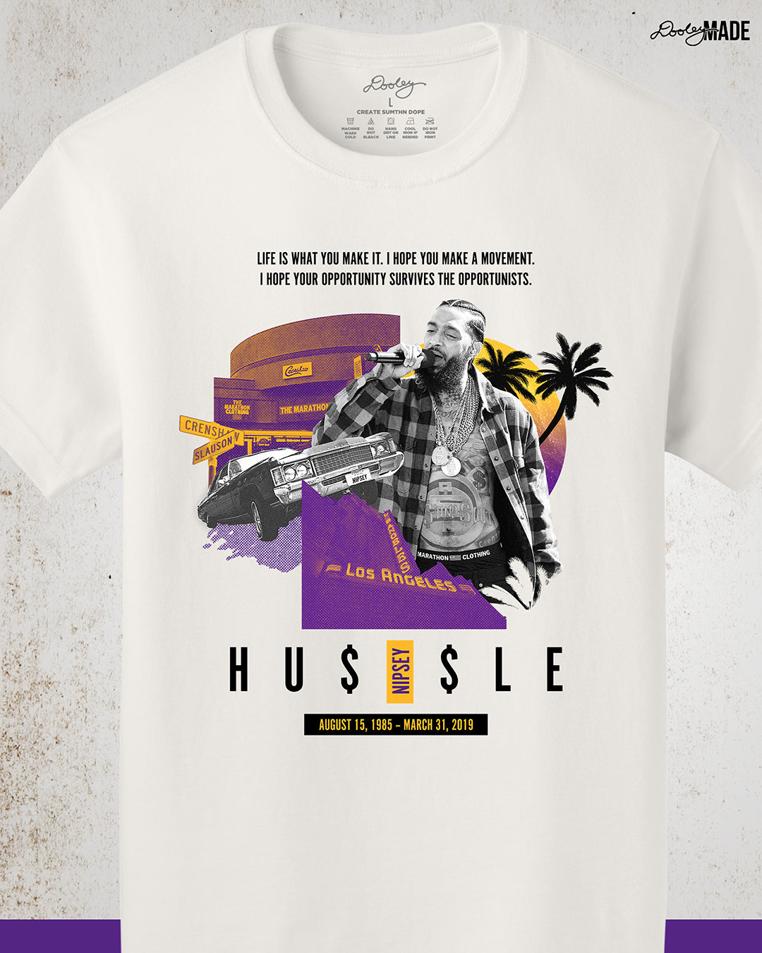 Vintage white Nipsey Hussle graphic t-shirt featuring “Sunsets on Slauson” artwork in LA purple and gold, depicting The Marathon Store on Slauson, a Chevy with NIPSEY plates, the Los Angeles Theatre marquee, a sunset, and palm trees—perfect hip-hop streetwear and Los Angeles apparel