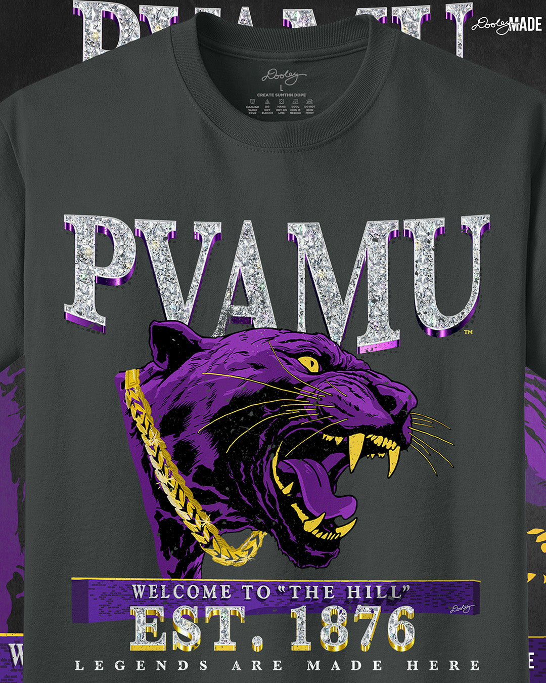 A a zoomed in 5.5-ounce, Coal colored 100% Pigment-Dyed Ring Spun Cotton k t-shirt with PVAMU text in diamonds featuring a purple panther, "Welcome to "The Hill," "Est. 1876," and "Legends Are Made Here" text.