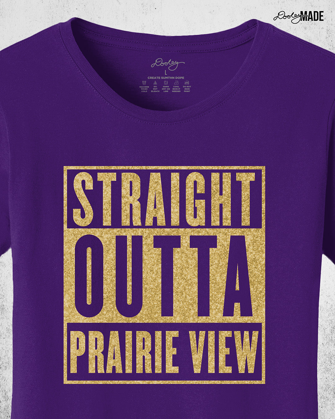 A purple, ladies cut Prairie View A&M University Shirt with "Straight Outta Prairie View" in a shinny golden design across the chest. Perfect for alumni, students, and gradates that want to celebrate their HBCU pride with a shine. Zoomed to show the detail.