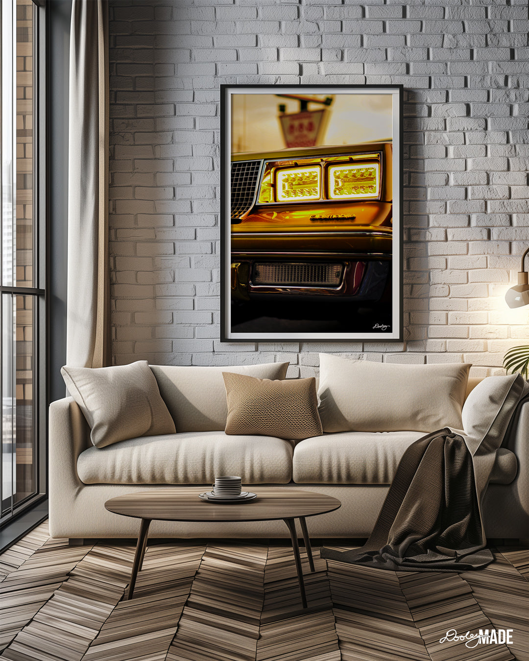 The image shows a close-up of a classic 1980s Oldsmobile's car's front end. The car is a beautiful golden color, and the headlights are on, casting a warm glow. The image is framed and hanging on a wall in a modern living room setting.