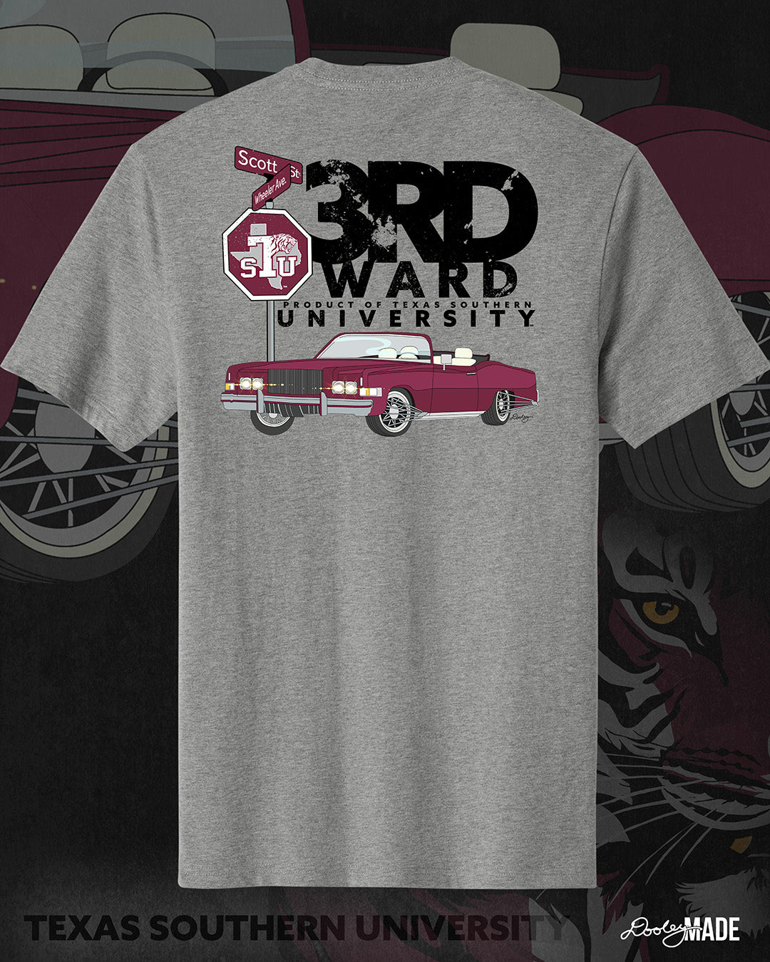 An image of the back of a heather gray Texas Southern University graphic tee shirt featuring a 3rd Ward University design and a maroon old school car with elbow rims. There is also a stop sign with the Texas Southern University logo on it and with the Scott St and Wheeler Ave intersection signs.