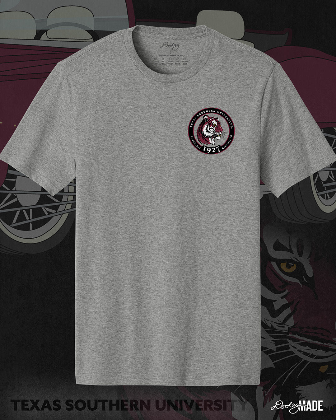 An image of the front of a heather gray Texas Southern University graphic tee shirt featuring a 3rd Ward University design and a maroon old school car with elbow rims. There is also a Scott St and Wheeler Ave street sign with a stop sign with the Texas Southern University logo on it. The front shows a circular print with the words Texas Southern University Established 1927 Houston, Tx around the border with a stylized tiger inside of it.