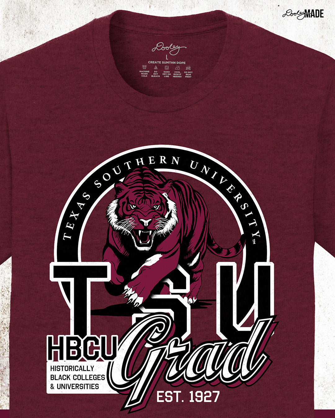 A athletic maroon Texas Southern University graduation crewneck sweater featuring a prowling tiger surrounded by a circular frame with the university name inside of it, and the words "TSU Grad" next to HBCU and Historically Black Colleges & University. Enlarged to show more details.