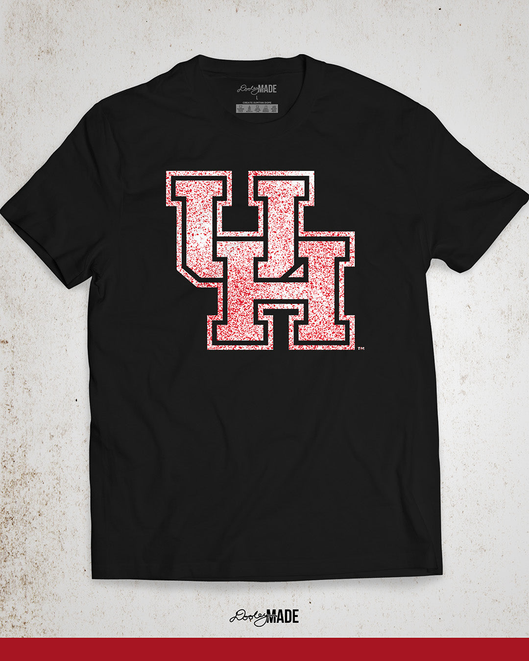 Image showing a red University of Houston shirt with a white UH logo with red speckles stretched across the front.