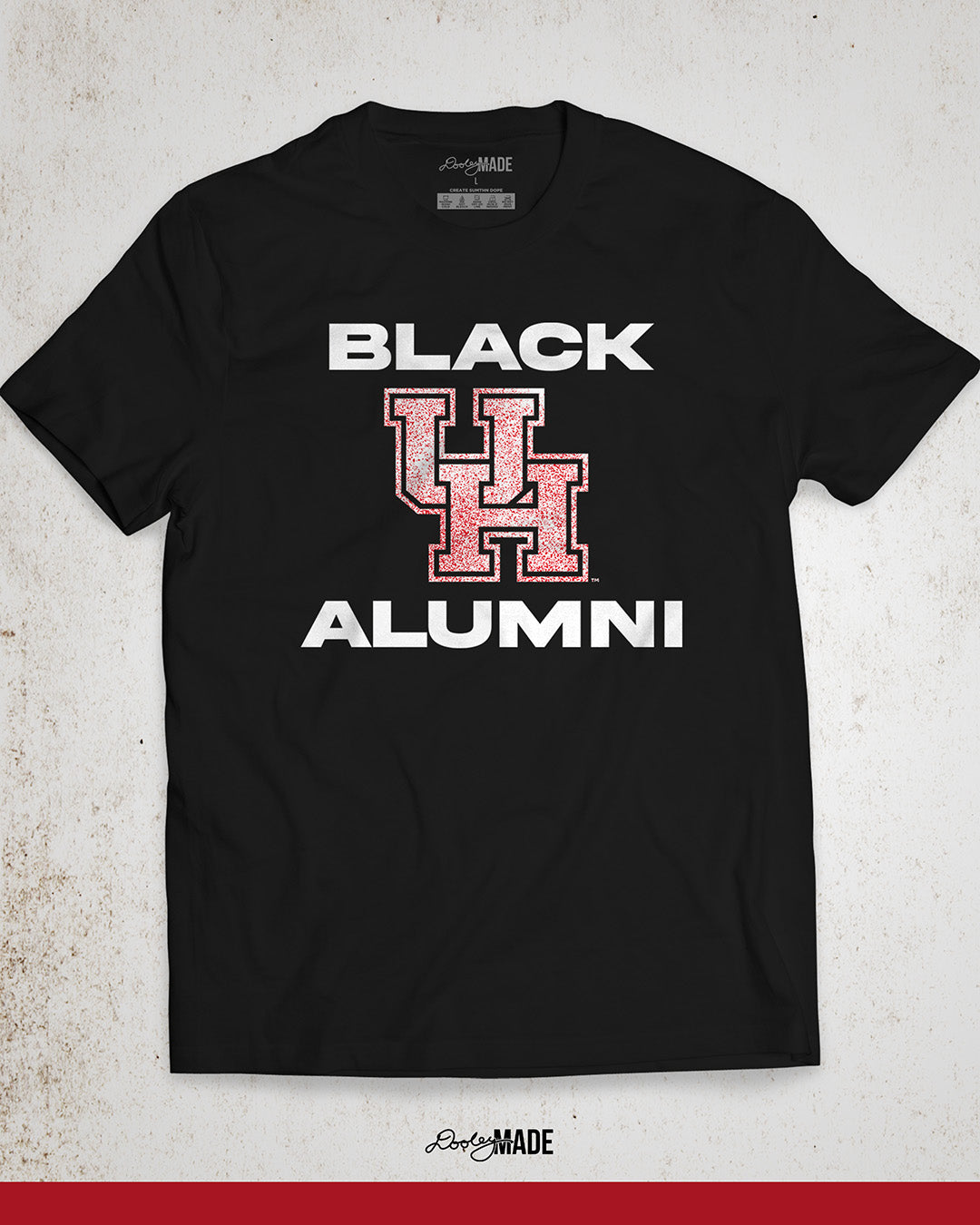 Image of a black University of Houston Black Alumni shirt with bold, white text reading "BLACK ALUMNI" surrounding a speckled red "UH" logo in the center. The design highlights pride and unity for Black Alumni of the University of Houston, presented on a modern and stylish garment perfect for showing school spirit.