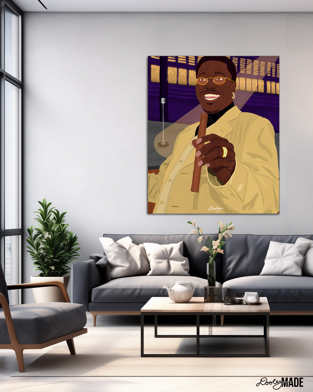 A beautiful illustration of Bernie Mac holding a cigar hanging on the wall above a couch in a modern living room.