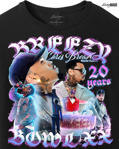 A zoomed Black crop top t-shirt with a pink, blue, and white graphic that says 'Breezy Bowl XX,' 'Chris Brown World Word Tour' and '20 Years.' The graphic also features a collection of stylized Chris Brown photos with pink and blue highlights. 