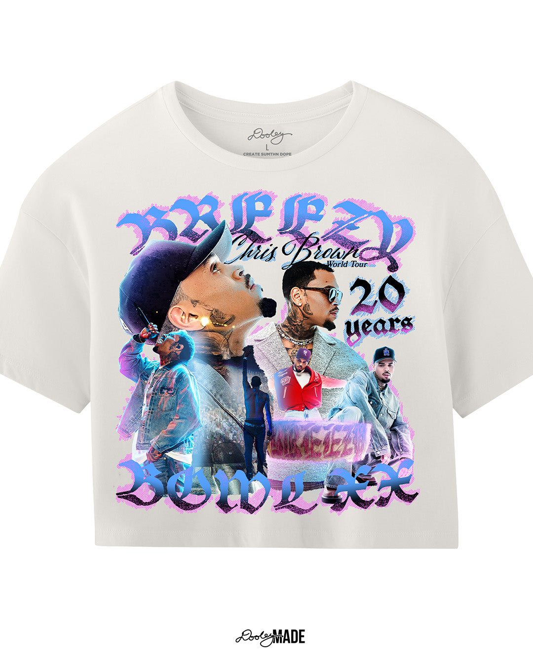 A Vintage White crop top t-shirt with a pink, blue, and black graphic that says 'Breezy Bowl XX,' 'Chris Brown World Word Tour' and '20 Years.' The graphic also features a collection of stylized Chris Brown photos with pink and blue highlights. 