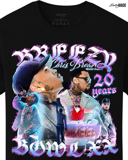 A zoomed in black oversized heavyweight t-shirt with a pink, blue, and white graphic that says 'Breezy Bowl XX,' 'Chris Brown World Word Tour' and '20 Years.' The graphic also features a collection of stylized Chris Brown photos with pink and blue highlights. 