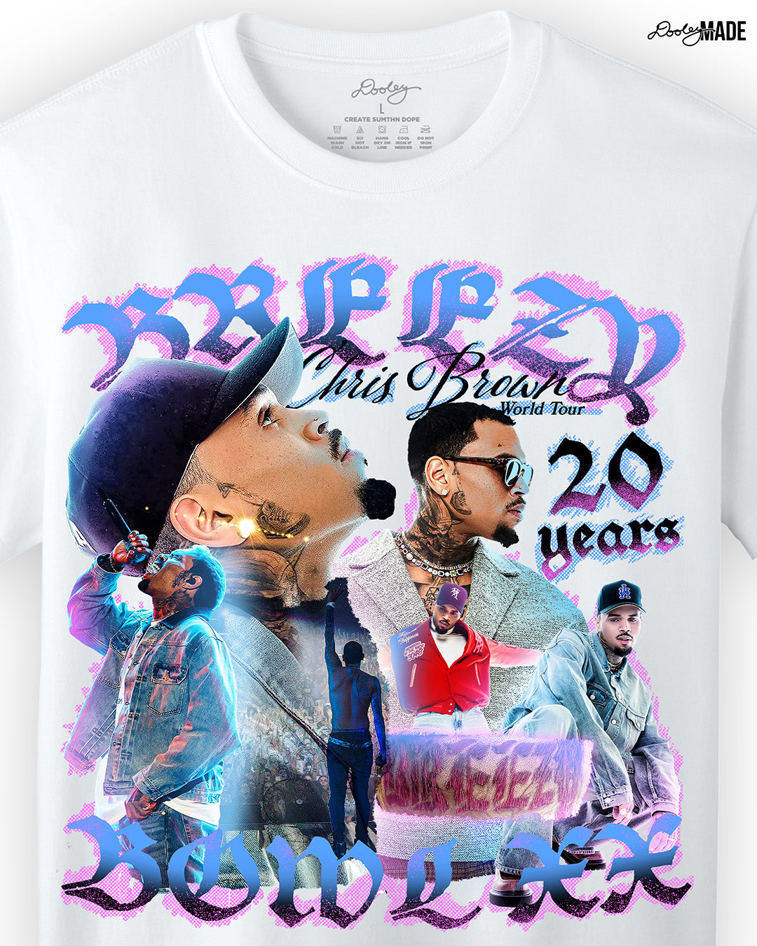A zoomed in white oversized heavyweight t-shirt with a pink, blue, and white graphic that says 'Breezy Bowl XX,' 'Chris Brown World Word Tour' and '20 Years.' The graphic also features a collection of stylized Chris Brown photos with pink and blue highlights. 