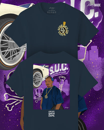 A premium navy shirt with an illustration of Houston DJ Screw on the back and his S.U.C medallion on the front. DJ Screw is depicted wearing headphones and a large gold chain with the "Screwed Up Click" medallion. The background features the acronym "S.U.C." (Screwed Up Click) in large letters, along with a white Cadillac with custom wire wheels, a screw, and a skull and crossbones symbol. The backdrop is a deep purple night sky with a city skyline silhouette, enhancing the urban and musical themes.