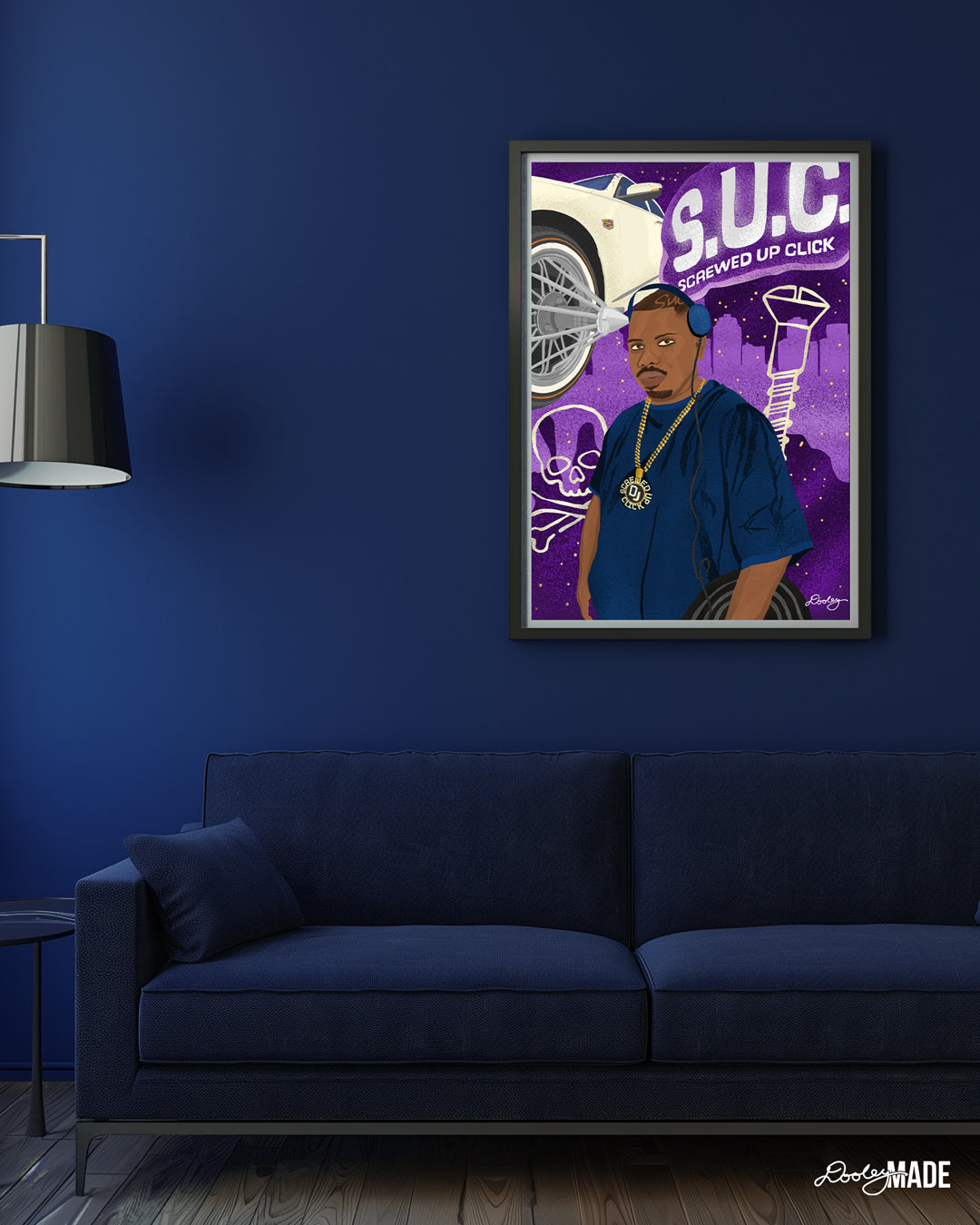 An image of a modern, minimalist living room with deep navy blue walls, creating a sophisticated atmosphere. A large black picture frame is on the wall with an illustrated, Houston themed DJ Screw print. In front of it, a plush navy blue sofa with clean lines rests on a dark wood floor, adding warmth. To the left, a small blue side table and a floor lamp with a dark blue shade provide functionality and elegance. The overall space exudes tranquility and sophistication.