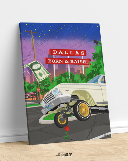 A mounted canvas print of The Dallas Concrete Rose artwork - a vibrant illustration by Dre Dooley of a classic 1964 Chevy Impala lowrider with gold wire wheels, hopping in the streets of Dallas. A red street sign reads "Dallas Born & Raised", set against a sunset city skyline. A floating $100 bill, power lines, and urban elements reflect the culture of Dallas, TX. A single red rose grows from a cracked street, symbolizing resilience and roots.