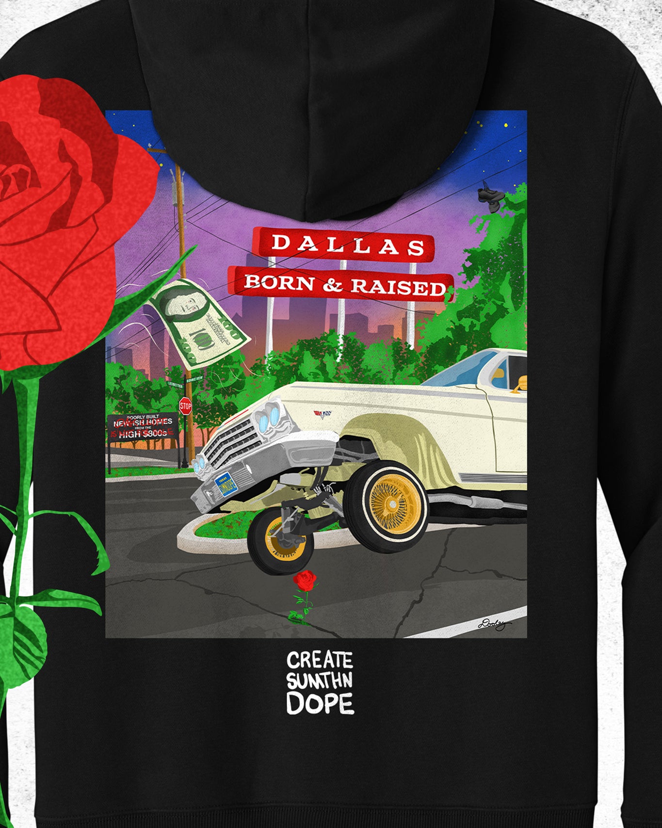 An image of heavyweight black hoodie from The Dallas Concrete Rose Collection featuring a vibrant illustration by Dre Dooley of a classic 1964 Chevy Impala lowrider with gold wire wheels, hopping in the streets of Dallas. A red street sign reads "Dallas Born & Raised", set against a sunset city skyline. A floating $100 bill, power lines, and urban elements reflect the culture of Dallas, TX. A single red rose grows from a cracked street, symbolizing resilience and roots.