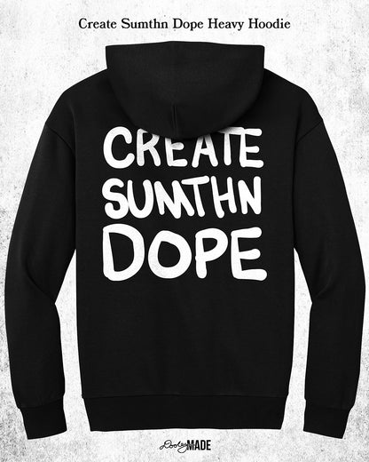 A heavy oversized Black hoodie with white 'CREATE SUMTHN DOPE' text on the back, displayed against a textured white background. Created by Dooley Made.