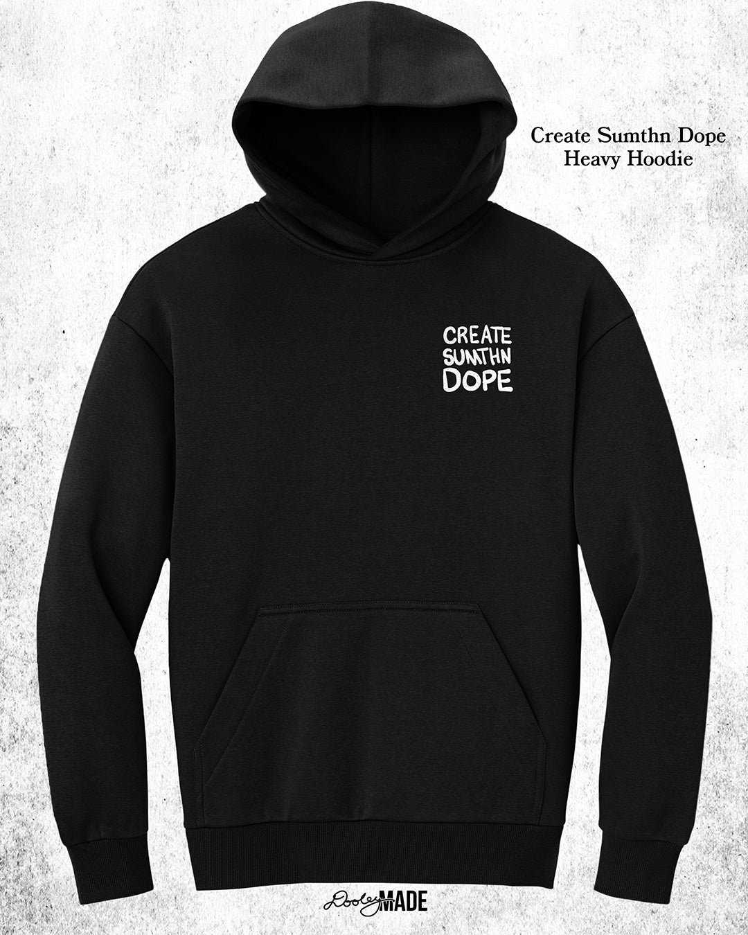 A heavy oversized Black hoodie with white 'CREATE SUMTHN DOPE' text on the left chest, displayed against a textured white background. Created by Dooley Made.