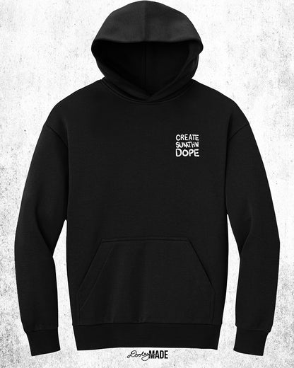 A heavy oversized Black hoodie with white 'CREATE SUMTHN DOPE' text on the left chest, displayed against a textured white background. Created by Dooley Made.