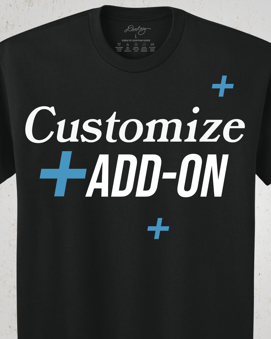 Black t-shirt with text 'Customize + Add-On' on a white background. Image is showing Dooley Made Custom Products Add On.
