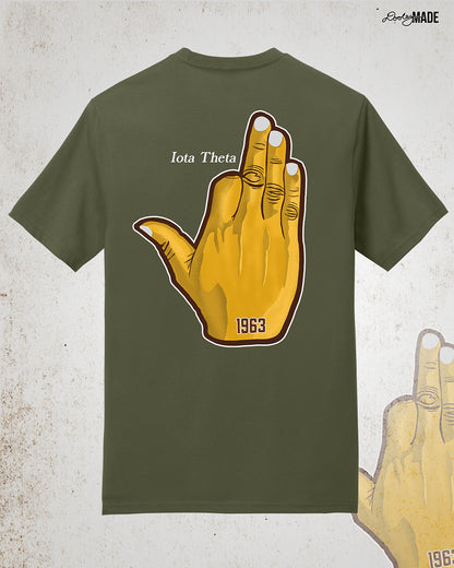 Image showing the back of a customizable Iota Phi Theta shirt with a large gold, brown, and white "Ow-Ow" hand sign with "1963," and the sample custom text "Iota Theta." Shirt is on a textured white background.
