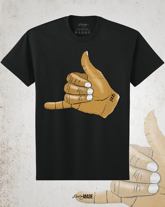 Black t-shirt with an old gold Alpha Phi Alpha Fraternity, Inc. "ICE" hand sign with "1906" text on the wrist. Image on grunge textured white background.