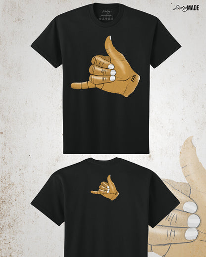 The front and back of a Black t-shirt with an old gold Alpha Phi Alpha Fraternity, Inc. "ICE" hand sign with "1906" text on the wrist. Image shows the design large on the front and smaller on the upper portion of the back. 