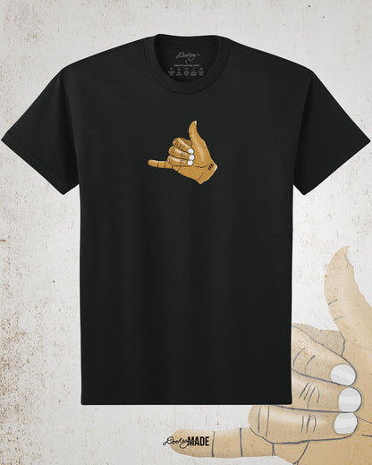 The front of a Black t-shirt with an old gold Alpha Phi Alpha Fraternity, Inc. "ICE" hand sign with "1906" text on the wrist. Image shows the design small on middle of the chest on the front of the shirt.