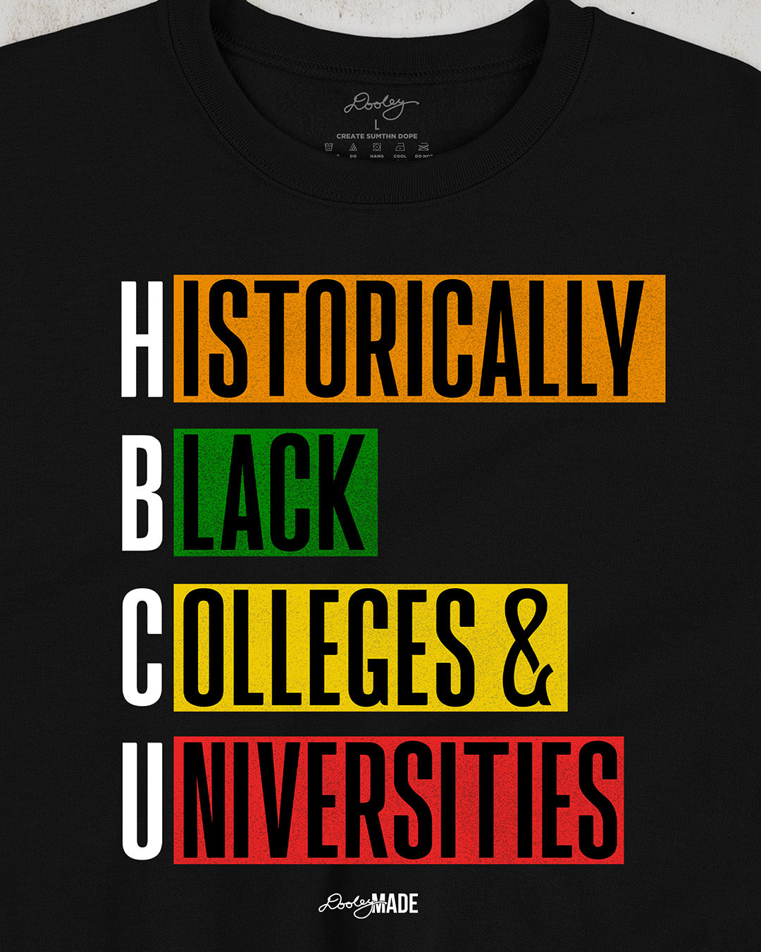 Black crewneck sweatshirt featuring bold block text reading "Historically Black Colleges & Universities" in red, yellow, green, and orange—HBCU pride apparel.