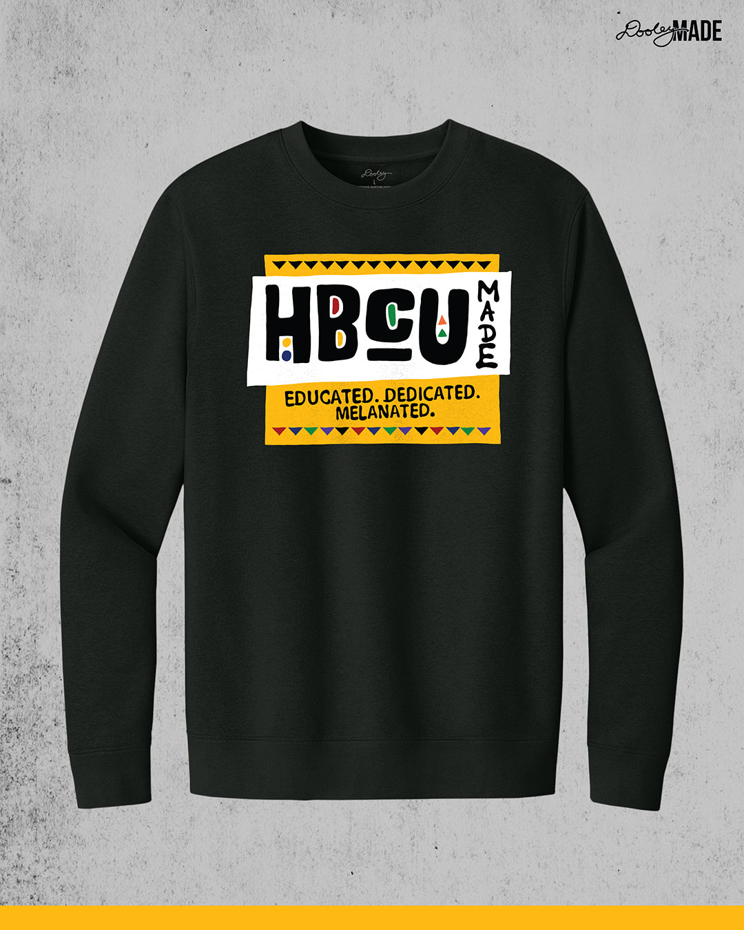 A premium black crewneck sweater featuring a bold HBCU Made 90s Martin Show themed design featuring the text "Educated, Dedicated, Melanated. The design is white, black, yellow, and various other vibrant colors.