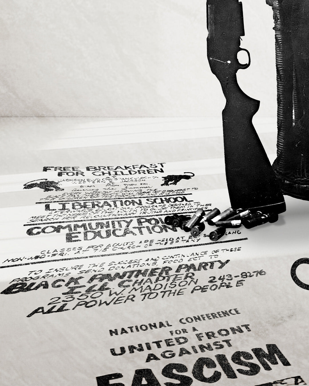 A zoomed image of Huey P. Newton artwork featuring a poster advertising the Black Panther Party's Free Breakfast Program, Liberation School, Community Politics Education Classes stretched in perspective across the floor under the butt of a gun and group of shotgun shells. It also shows words "National Conference for a United front against Fascism. 