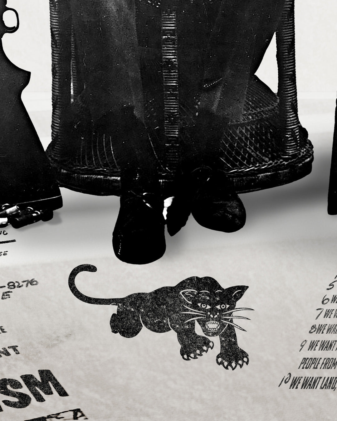 An zoomed image of Huey P. Newton artwork showing his feet and the Black Panther Party's illustrated panther logo icon stretched on the floor. 