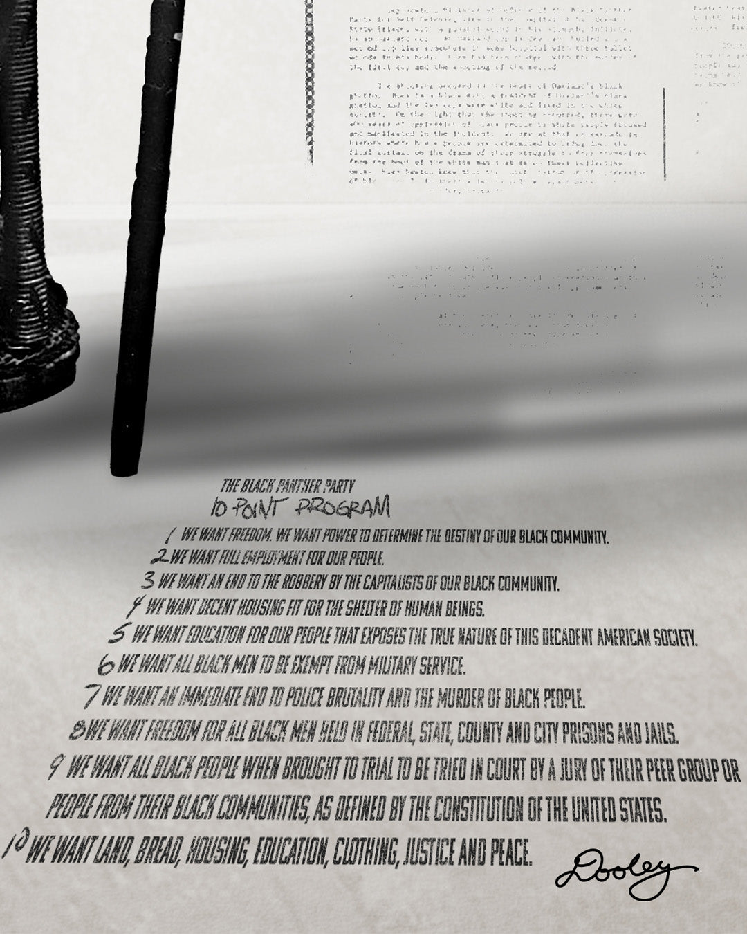 A zoomed image of Huey P. Newton artwork featuring the Black Panther Party's 10 Point Program outstretched in perspective on the floor. 