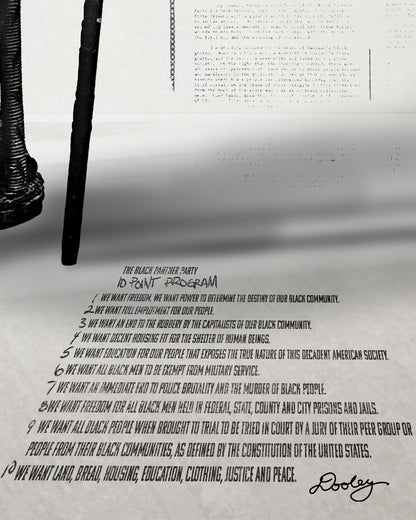 A zoomed image of Huey P. Newton artwork featuring the Black Panther Party's 10 Point Program outstretched in perspective on the floor. 