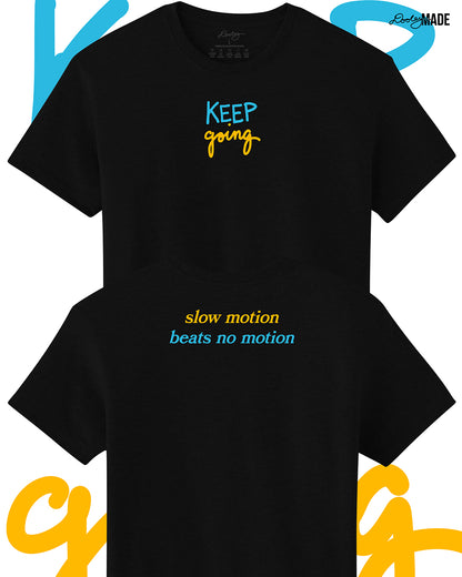 Heavyweight Black t-shirt with 'KEEP going' and 'slow motion beats no motion' text in blue and yellow on a white background. Shirts are stacked on each other vertically.