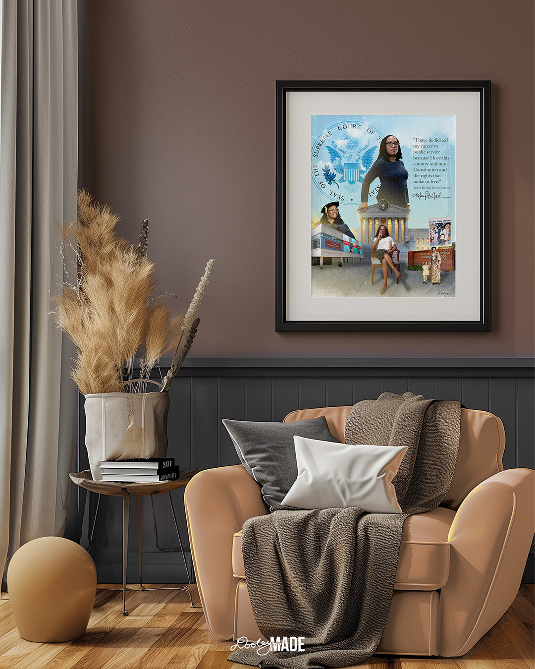 An image of a black picture frame on a brown wall in a sitting room showing a collage honoring Justice Ketanji Brown Jackson. It showcases key moments from her life and career. The central figure is a confident Justice Jackson standing in front of the Supreme Court seal. To the left, she is depicted at her Harvard Law School graduation, with the school's building in the background. 