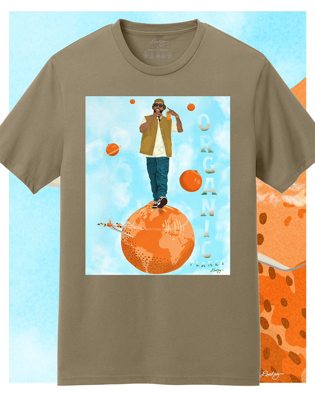 A khaki tan Larry June themed graphic t-shirt featuring a Larry June illustration of him standing on an orange planet with smaller floating orange planets, alongside the text "Organic Planet." Bold casual wear design blending creativity, luxury, and hip-hop culture. 