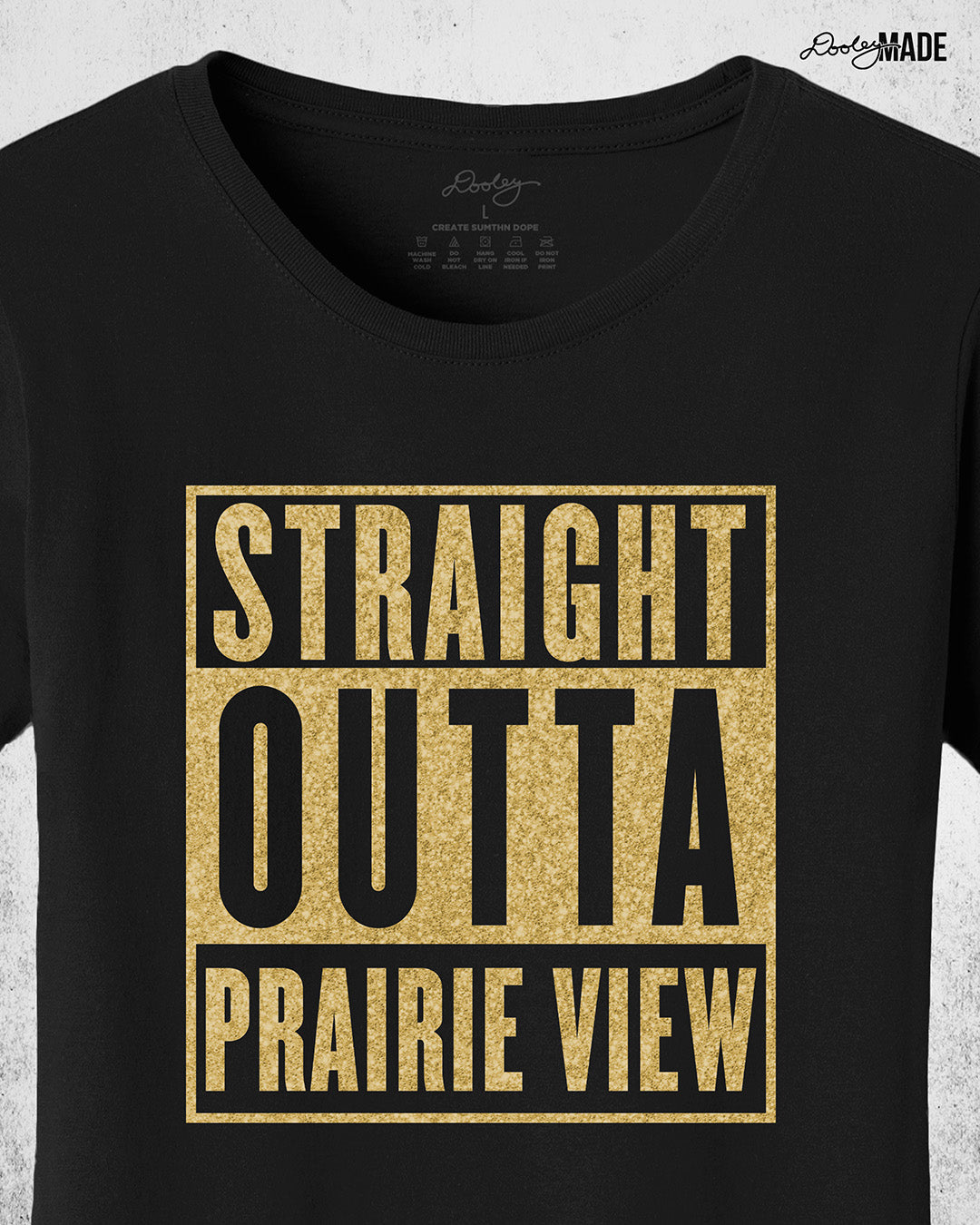 A Black, ladies cut Prairie View A&M University Shirt with "Straight Outta Prairie View" in a shinny golden design across the chest. Perfect for alumni, students, and gradates that want to celebrate their HBCU pride with a shine. Zoomed to show detail.