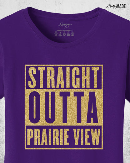 A purple, ladies cut Prairie View A&M University Shirt with "Straight Outta Prairie View" in a shinny golden design across the chest. Perfect for alumni, students, and gradates that want to celebrate their HBCU pride with a shine. Zoomed to show the detail.